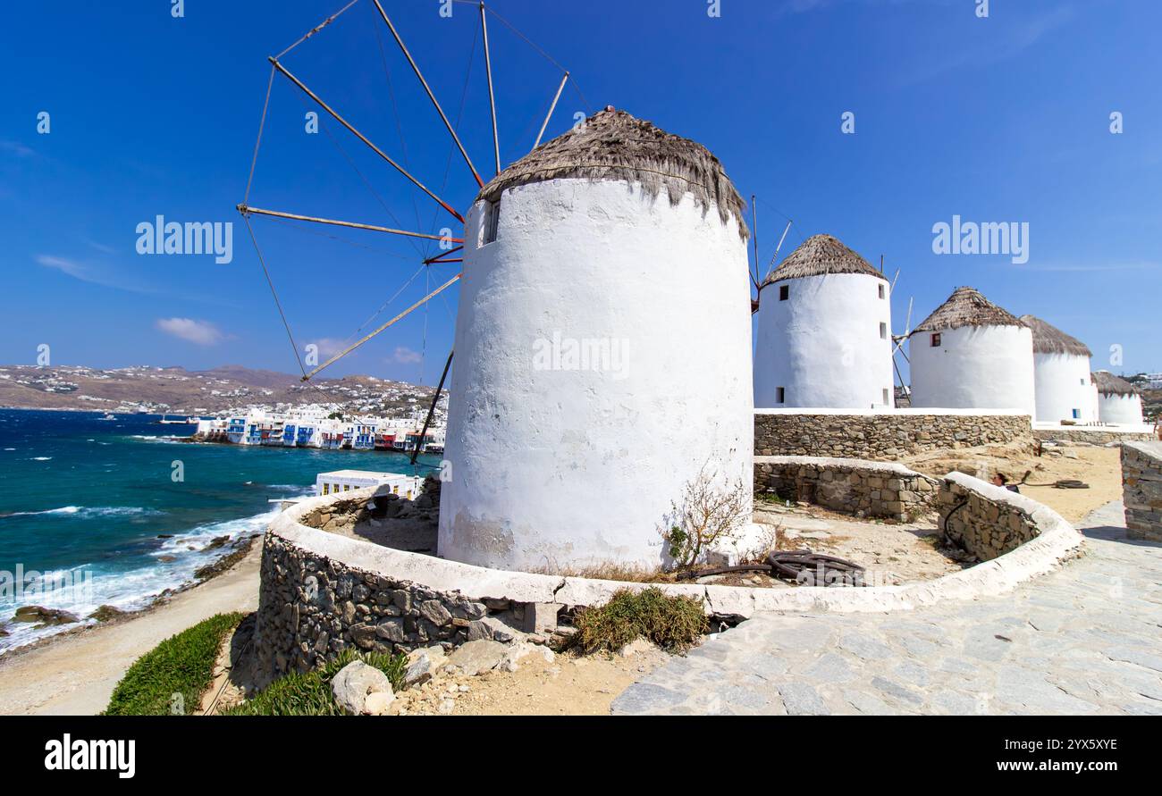 traditional-greek-windmills-on-mykonos-island-under-cloudy-sky-aerial