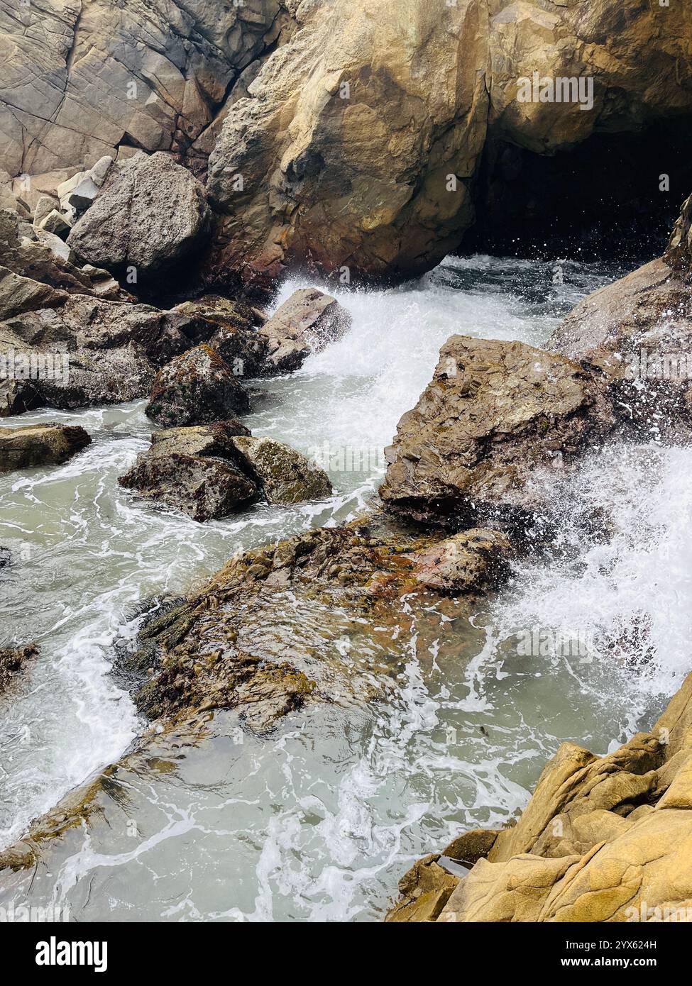 Rocky Coastal Waves Crashing Against Cliffside Rocks - Smartphone Captured Stock Image