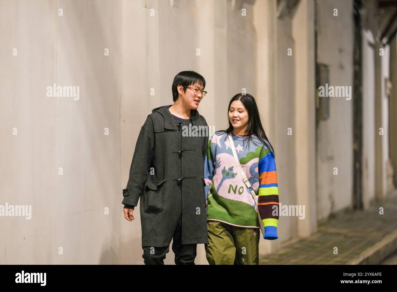 Asian couple walking talking in hi-res stock photography and images - Alamy