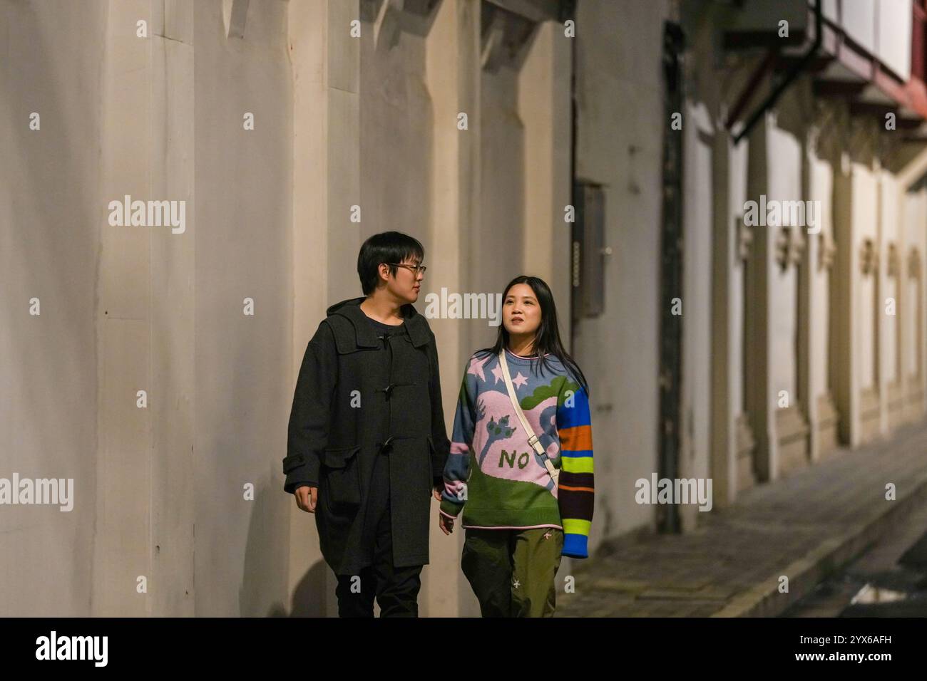 Asian couple walking talking in hi-res stock photography and images - Alamy