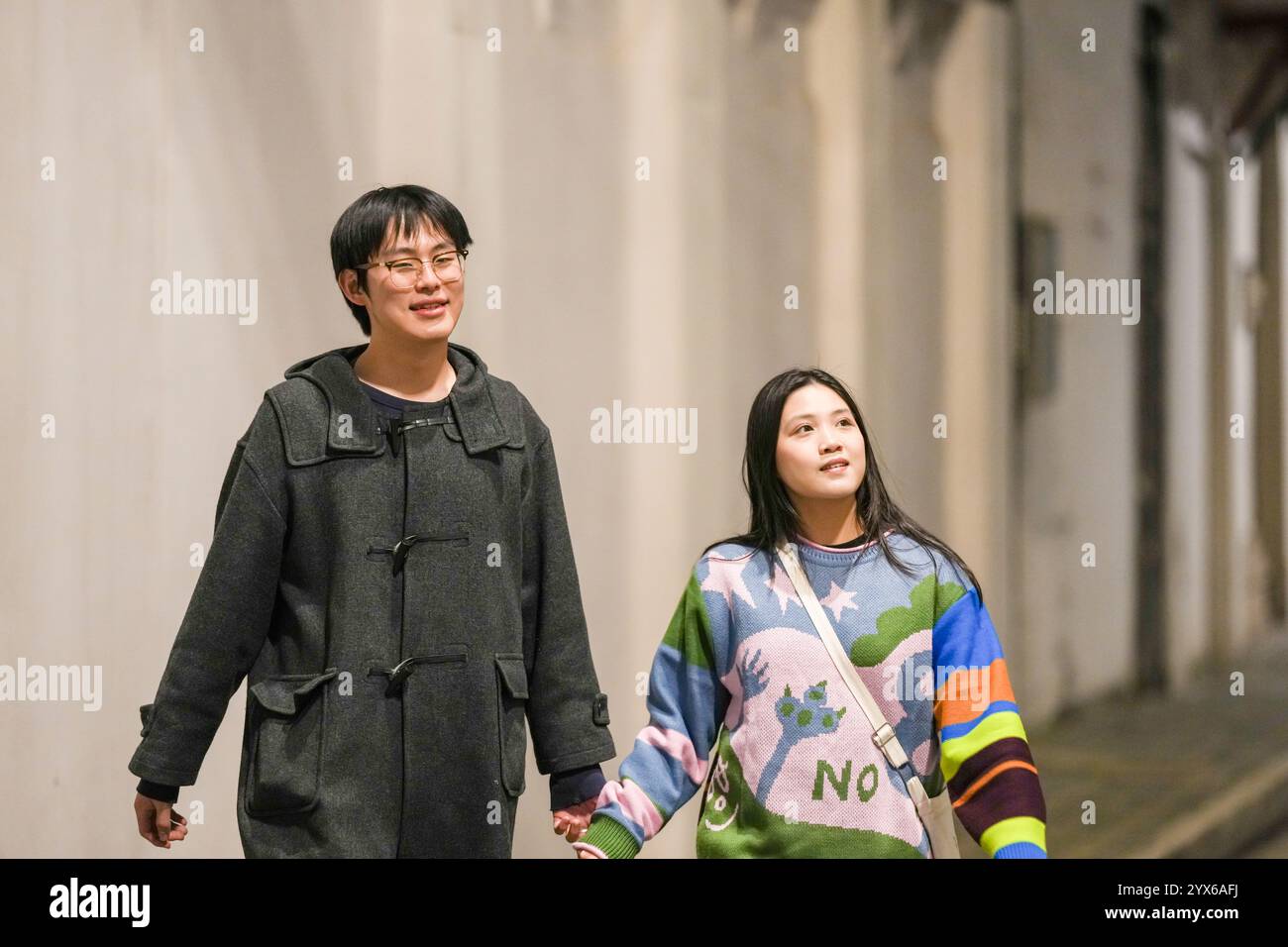 Asian couple walking talking in hi-res stock photography and images - Alamy