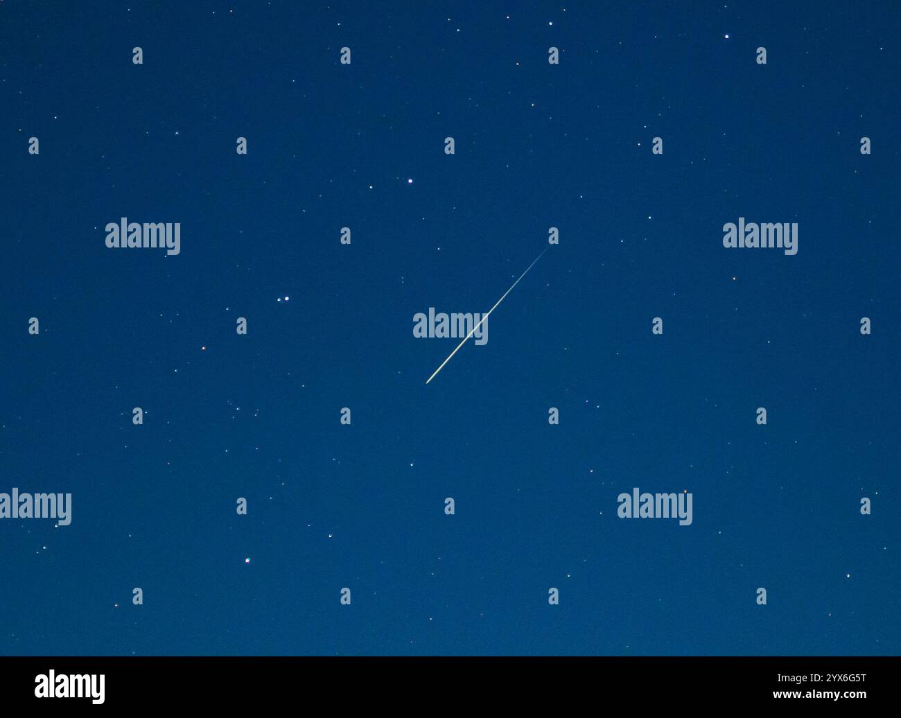 Lietzen, Germany. 14th Dec, 2024. A shooting star shines in the night sky over eastern Brandenburg. The Geminid meteor shower peaked on the night of December 13-14. Credit: Patrick Pleul/dpa/Alamy Live News Stock Photo