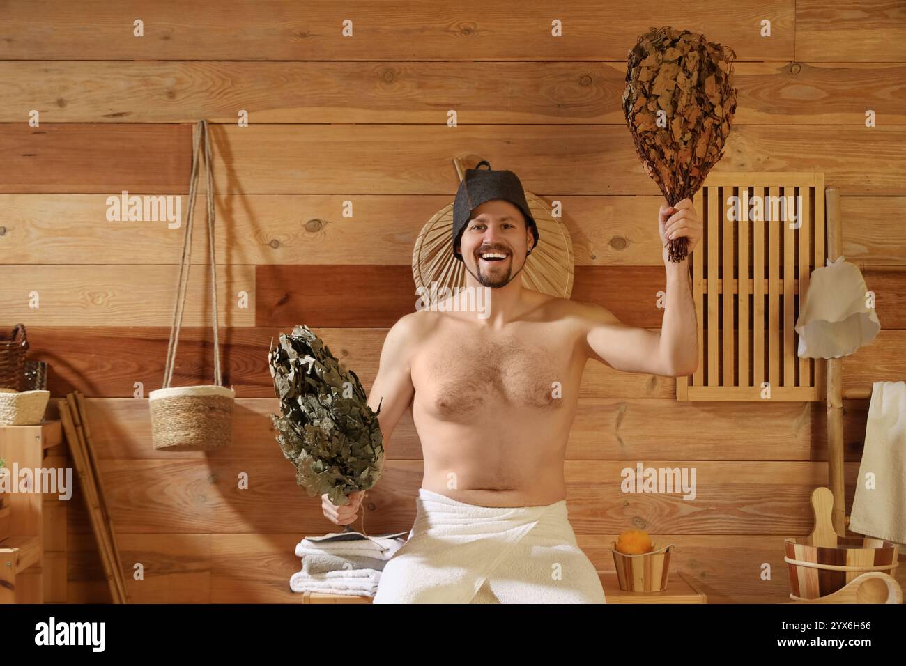 Handsome man with whisks in sauna Stock Photo