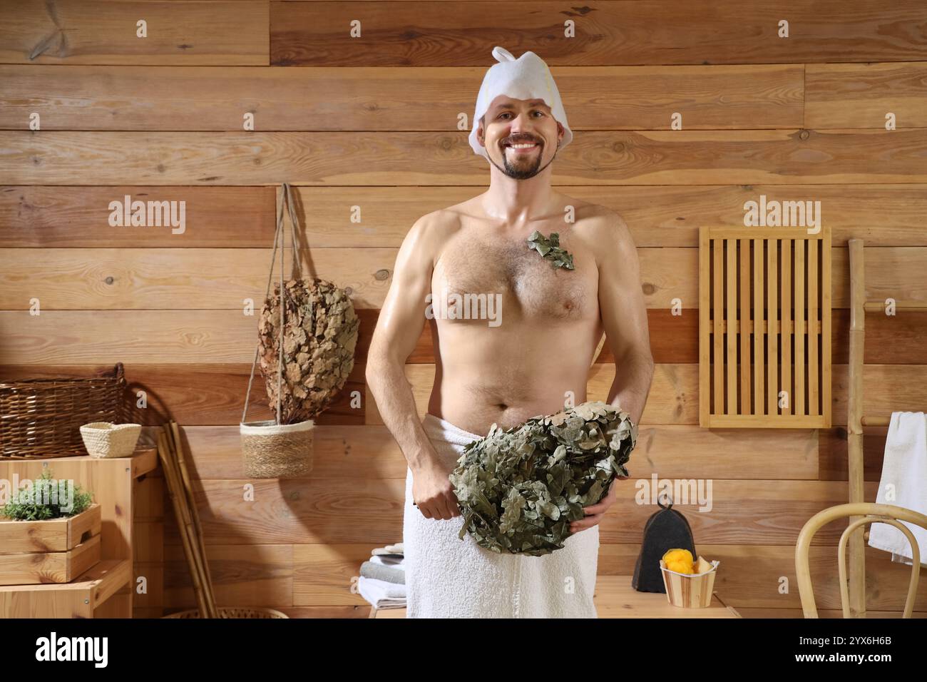 Handsome man with whisk in sauna Stock Photo