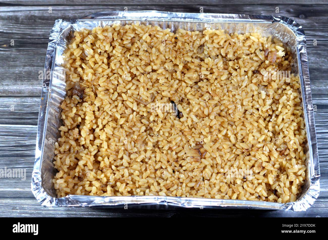 Cooked white Egyptian rice by hot steam and gained the brown color from ...