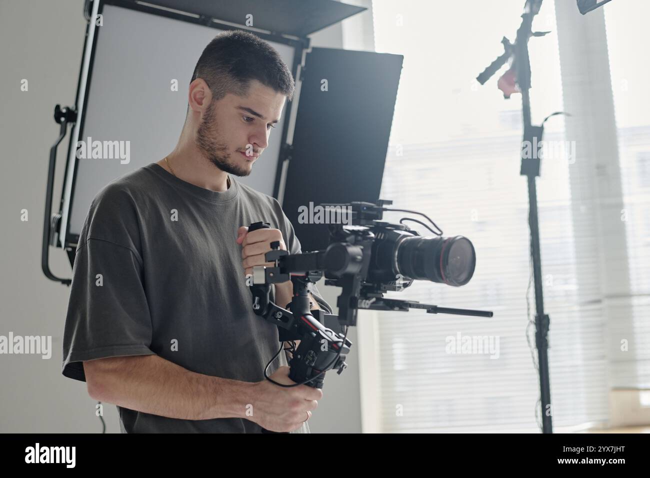 Medium close up of talented operator with massive camera enjoying ...