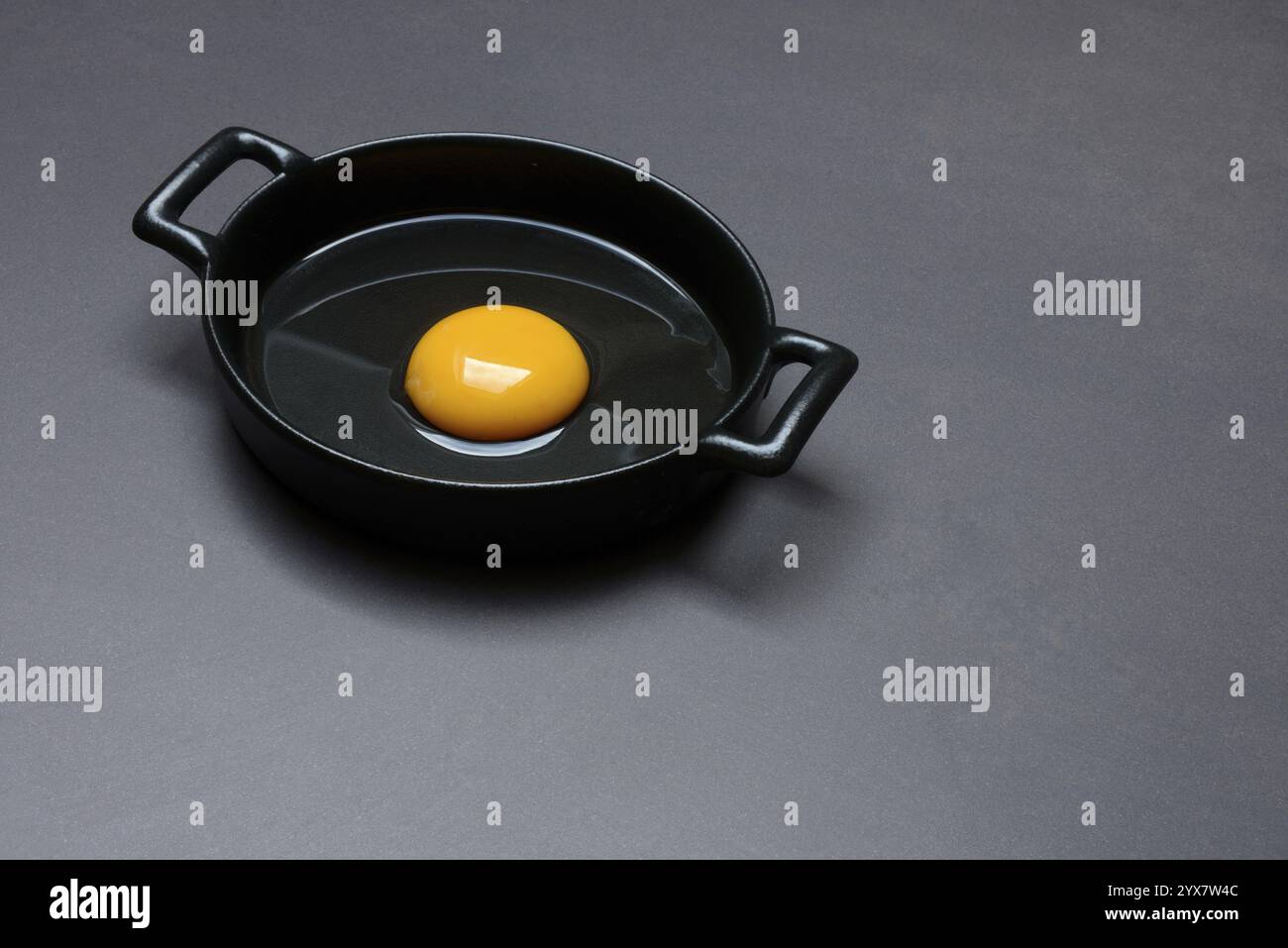 Cracked egg in a pan, hen's egg Stock Photo