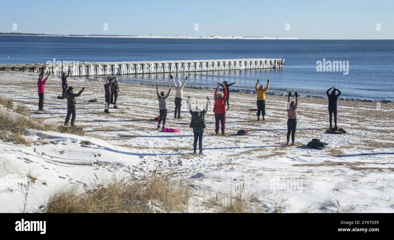 Group of exercisers in winter on the beach in Ystad, Skane County, Sweden, Baltic Sea, Scandinavia, Europe Stock Photo