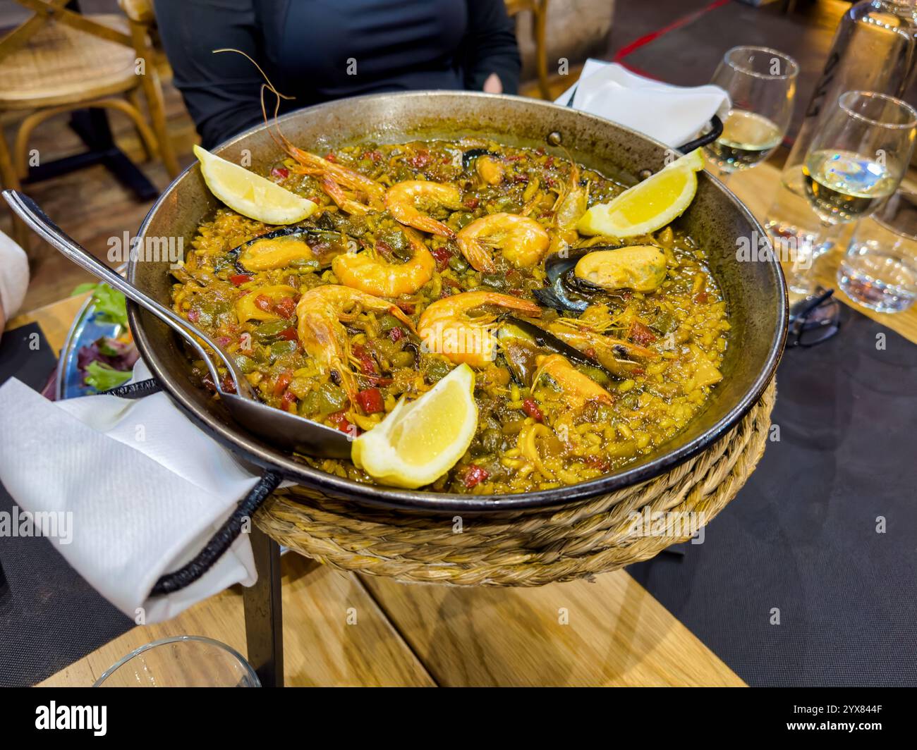 Freshly cooked Paella server on a table in a resturant in spain Stock Photo