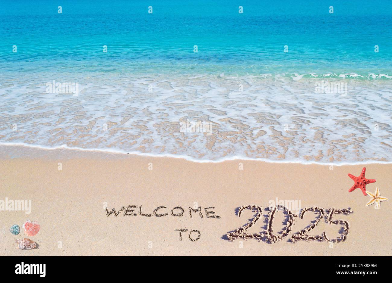turquoise water and golden sand with shells and sea stars with 'welcome to 2025' written on it Stock Photo