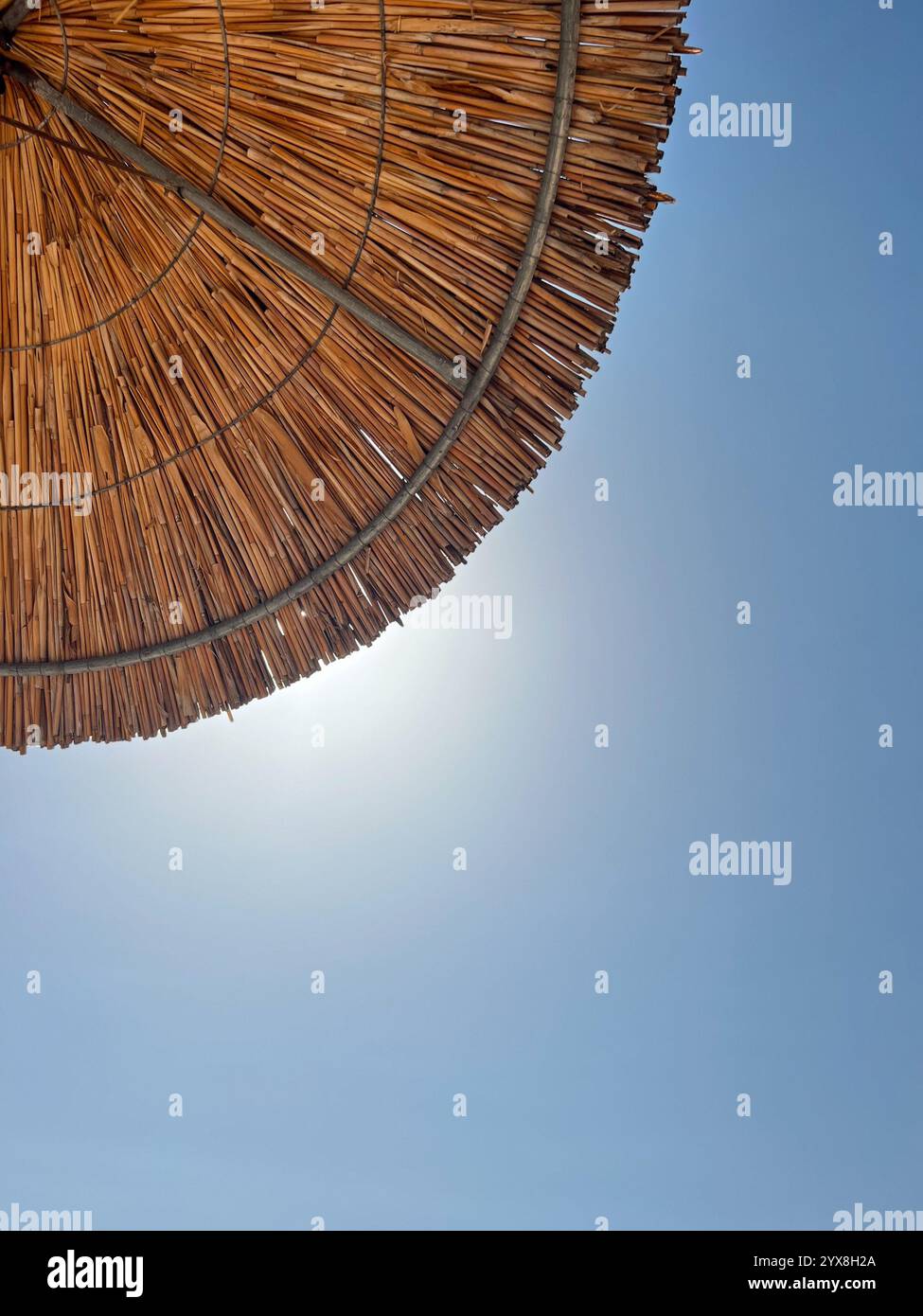 Beach bar with umbrellas in Greece at summer time - Smartphone Captured Stock Image