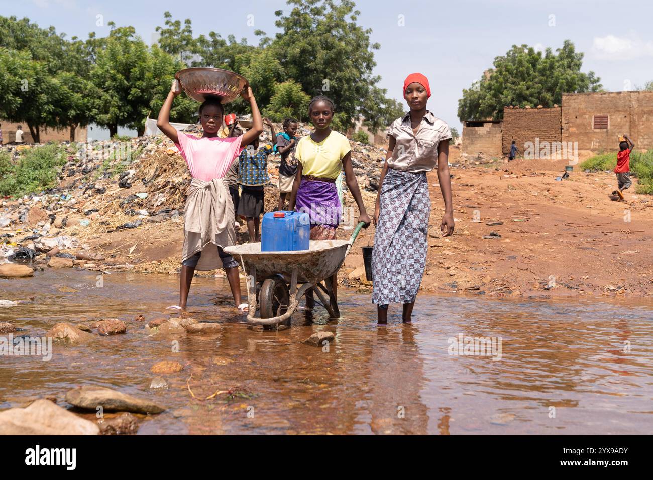 Focus on African rural development problems, such as child labor, lack of water supply and infrastructure, droughts and floods due to climate change, Stock Photo