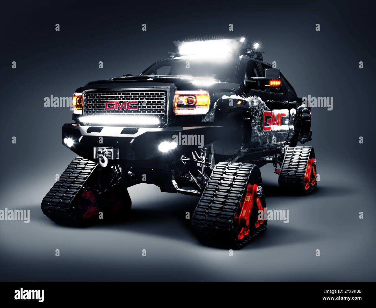 GMC pickup truck outfitted with Mattracks rubber snow tracks instead of ...