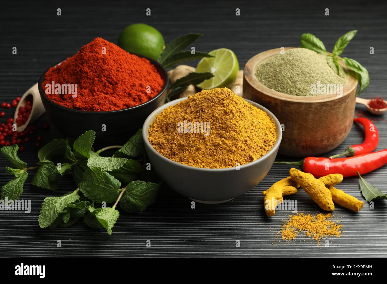 Different aromatic spices and herbs on black background, closeup Stock ...