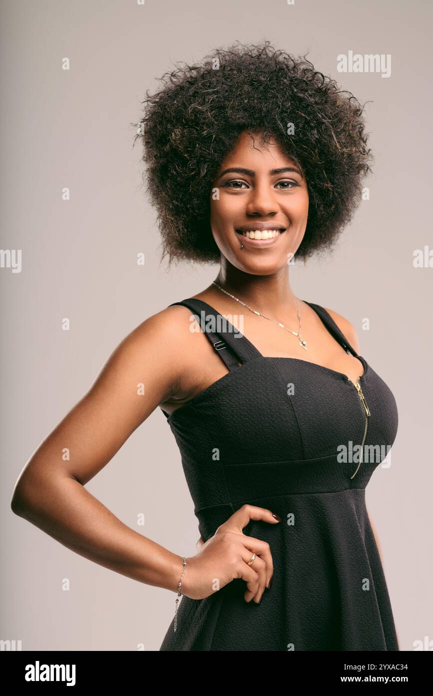 Studio portrait of a cheerful young latin american woman with curly ...