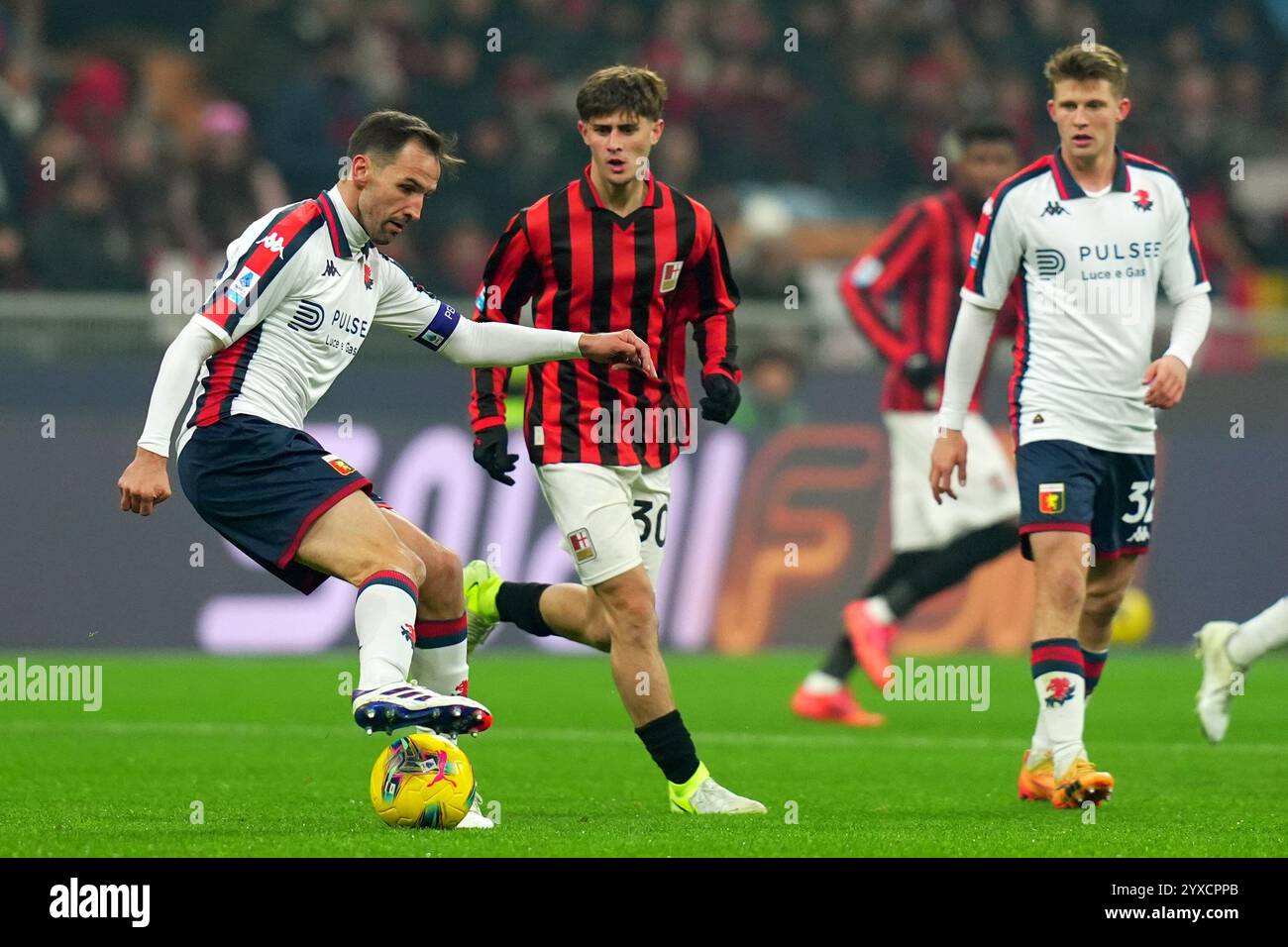 Milano, Italia. 15th Dec, 2024. ZGenoa's Milan Badelj fight for the ball with AC Milan's Mattia Liberali during the Serie A soccer match between Milan and Genoa at San Siro Stadium in Milan, North Italy - Sunday, December 15, 2024. Sport - Soccer . (Photo by Spada/LaPresse) Credit: LaPresse/Alamy Live News Stock Photo