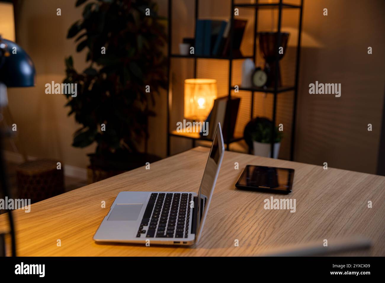 Create a Cozy Home Office Setup Featuring a Laptop and Tablet for Productive Work Days Stock Photo