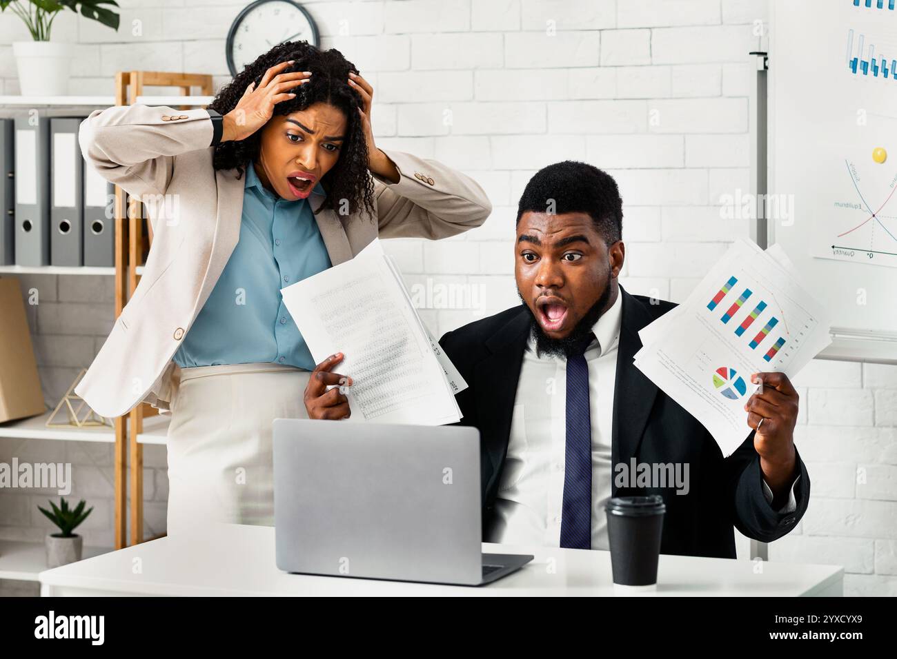 Stressed African American colleagues missing project deadline at office Stock Photo