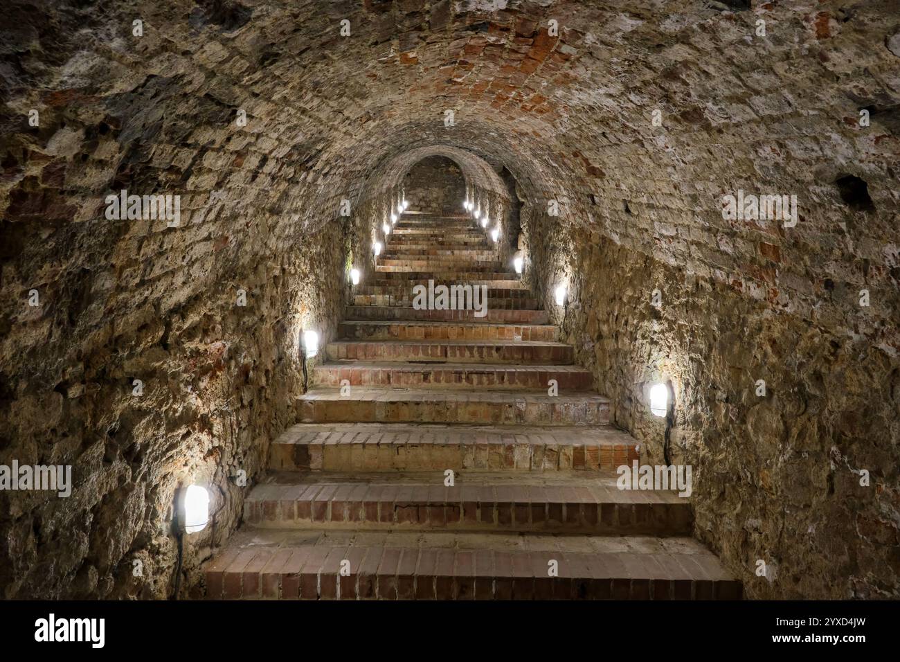 A long set of steps leads up through an ancient stone tunnel in a 13th ...
