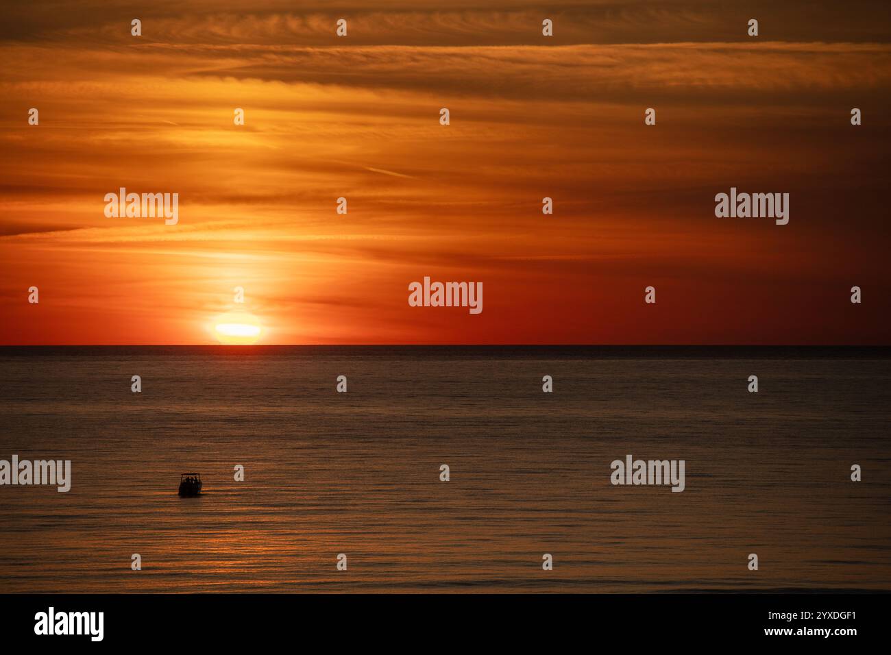 Sunset (or sundown) with a boat at Marco Island, Gulf of Mexico, Florida Stock Photo