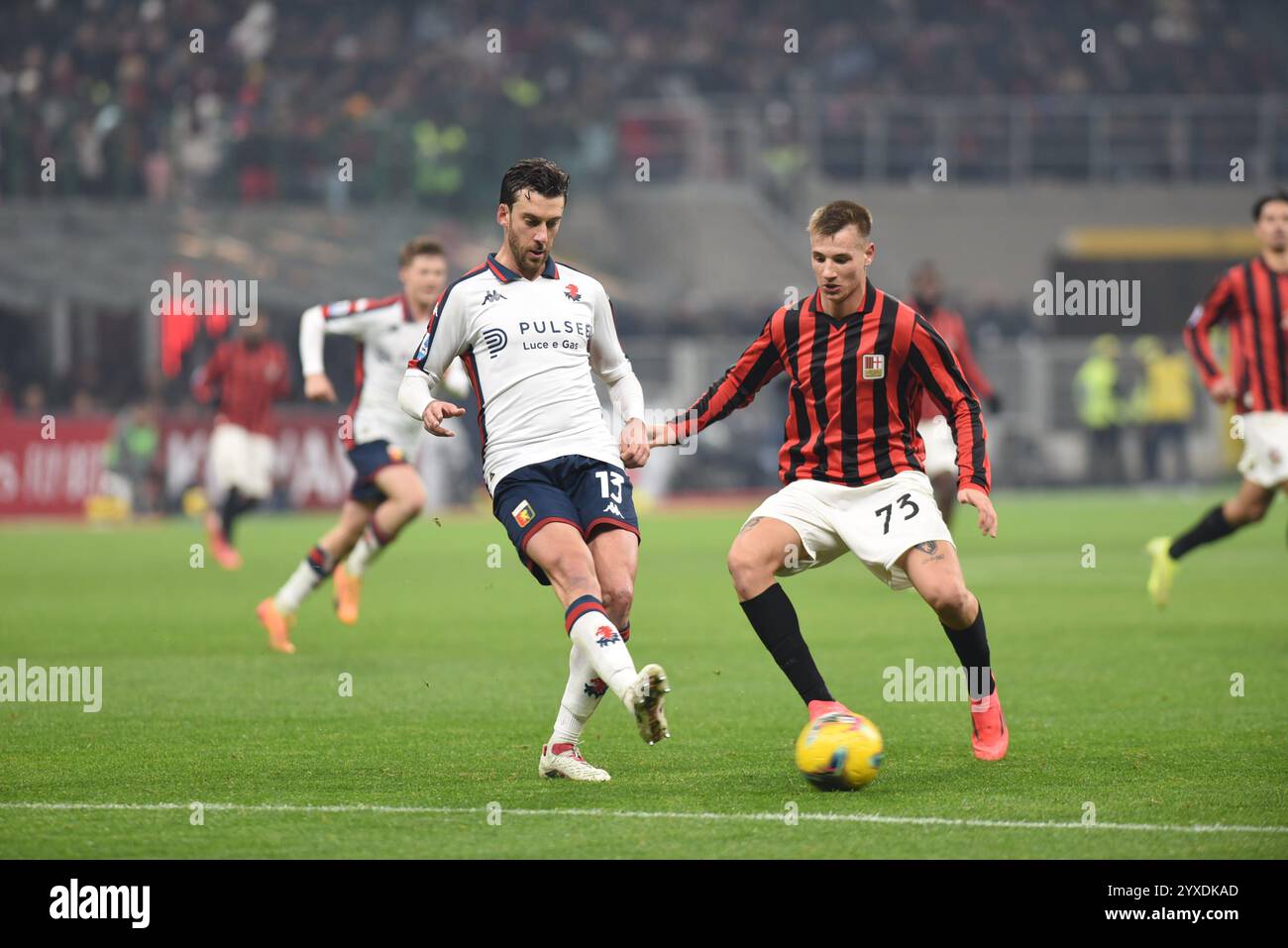 Milan, Italy. 15th Dec, 2024. MATTIA BANI (left) and FRANCESCO CAMARDA (right) fighting for the ball between the opposing players during the Serie A TIM football match between AC Milan and Genoa CFC at the San Siro Stadium (Credit Image: © Ervin Shulku/ZUMA Press Wire) EDITORIAL USAGE ONLY! Not for Commercial USAGE! Stock Photo