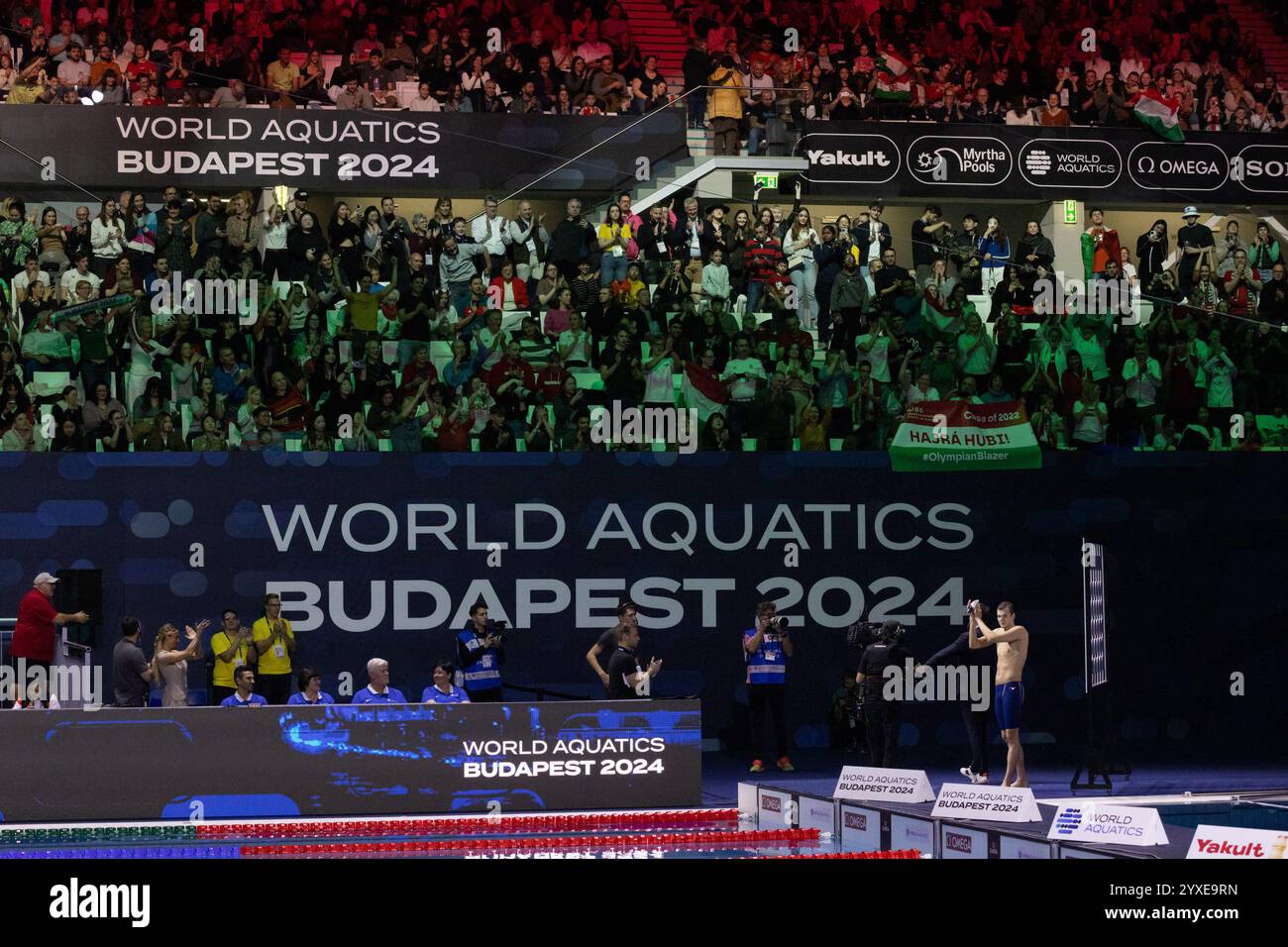 Budapest. 15th Dec, 2025. Hubert Kos (1st R) of Hungary reacts after