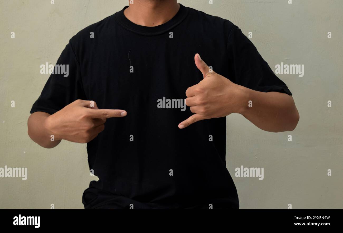 Young man showing CALL ME gesture in sign language Stock Photo