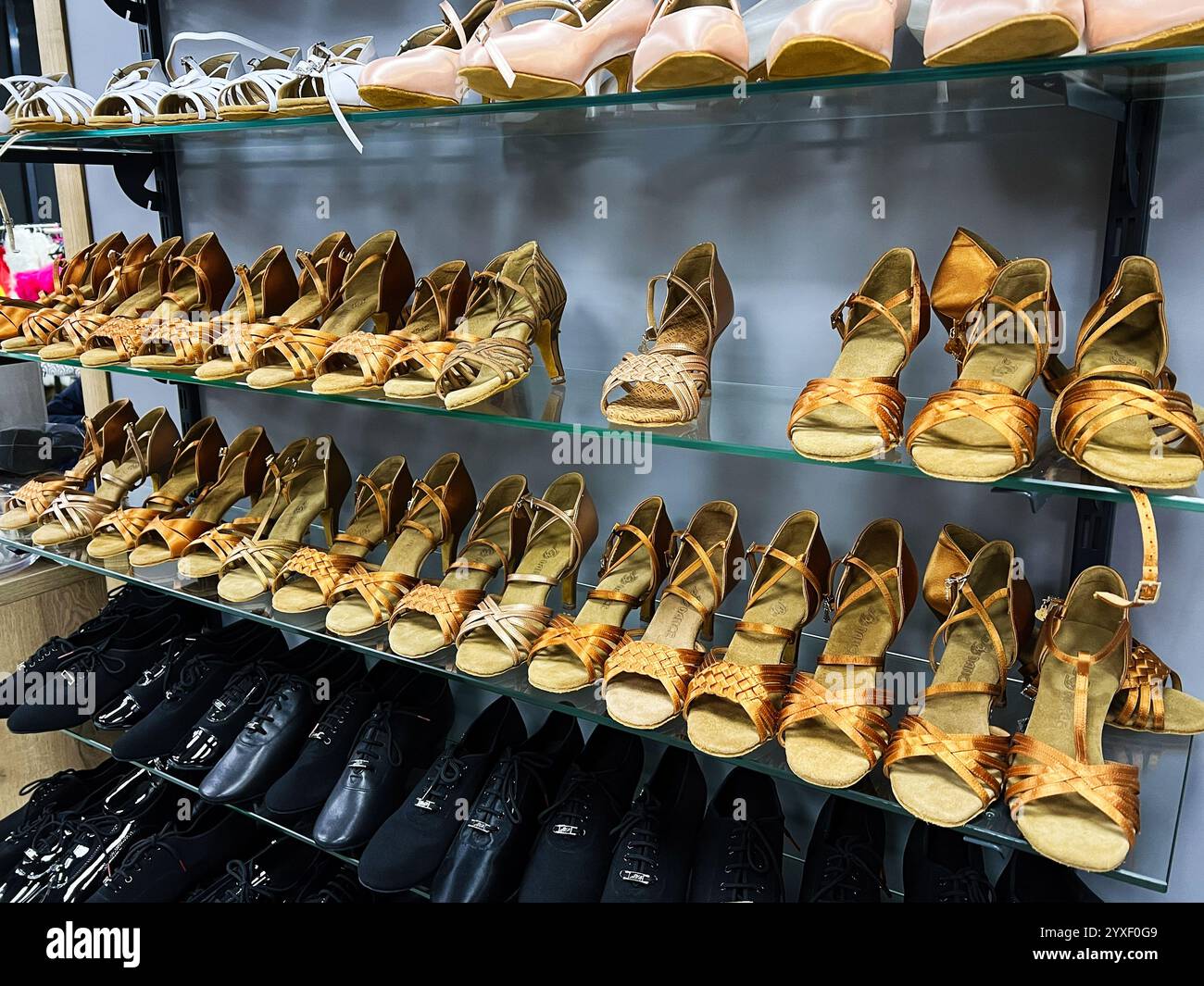 A collection of cheer shoes on display, showcasing different colors and styles