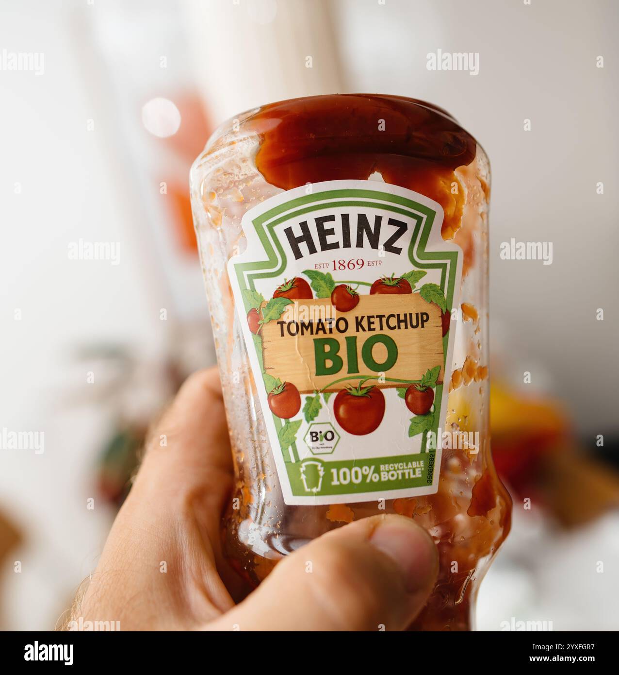 A row of Plastic Heinz Tomato Ketchup bottles on a supermarket shelf