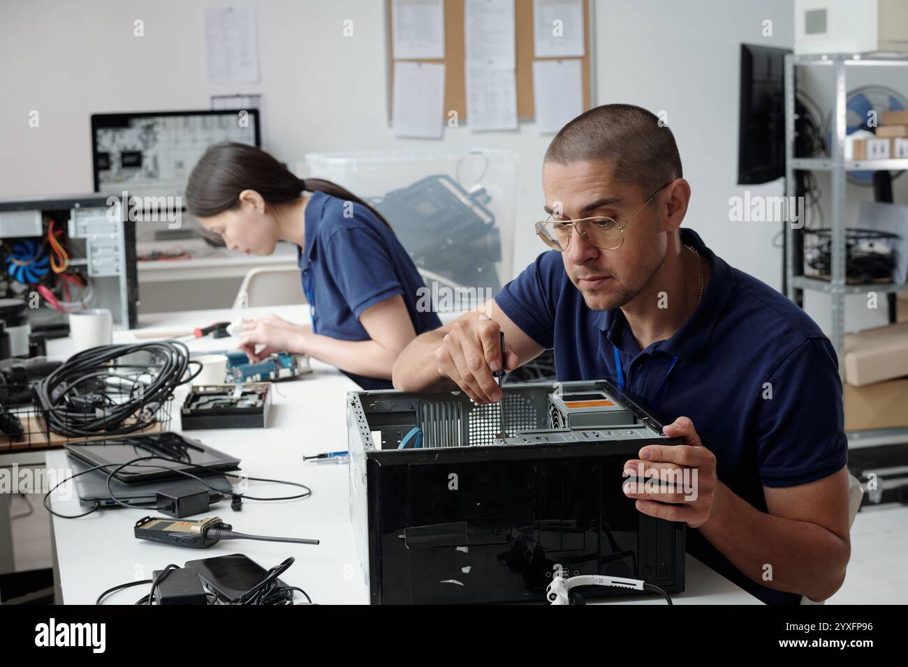 Fixing Computer Hardware in Technology Workshop Stock Photo