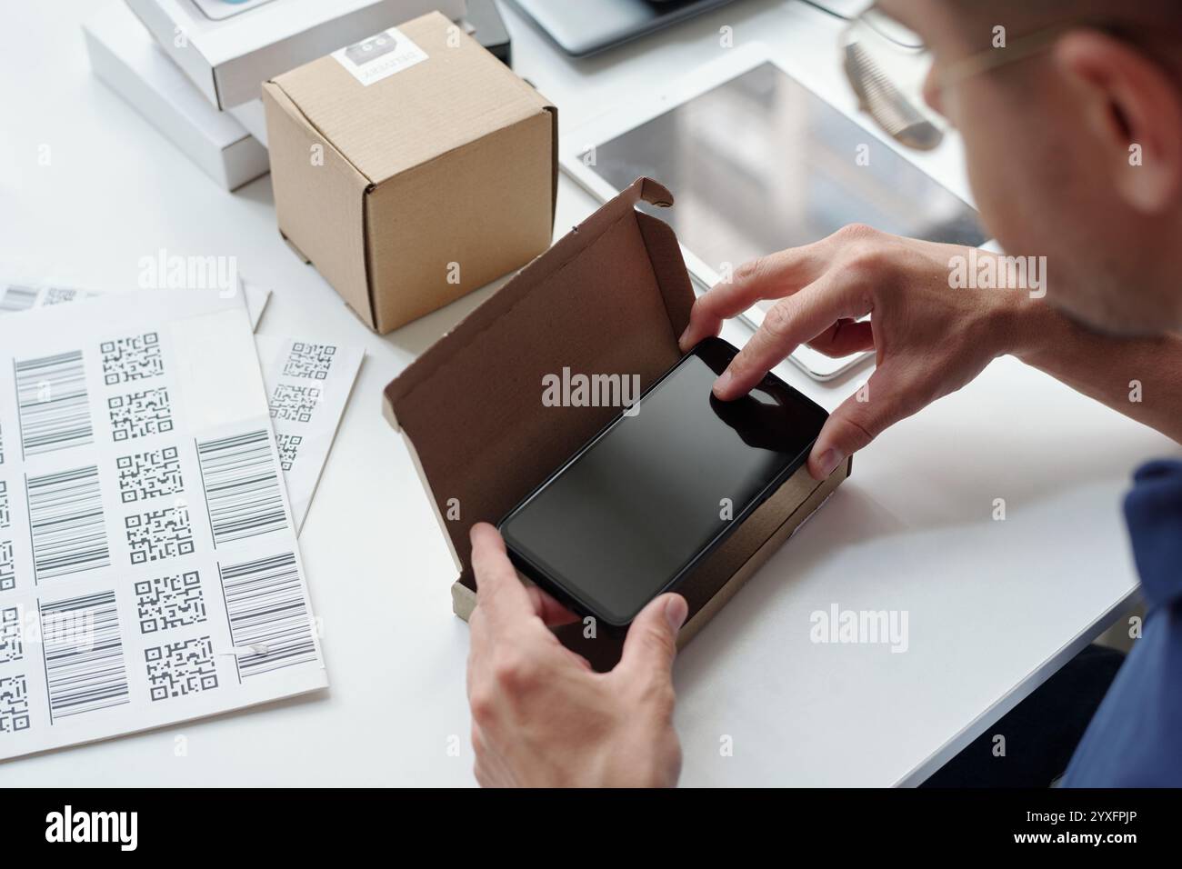 Packaging Smartphone in Box with Barcode Labels Stock Photo