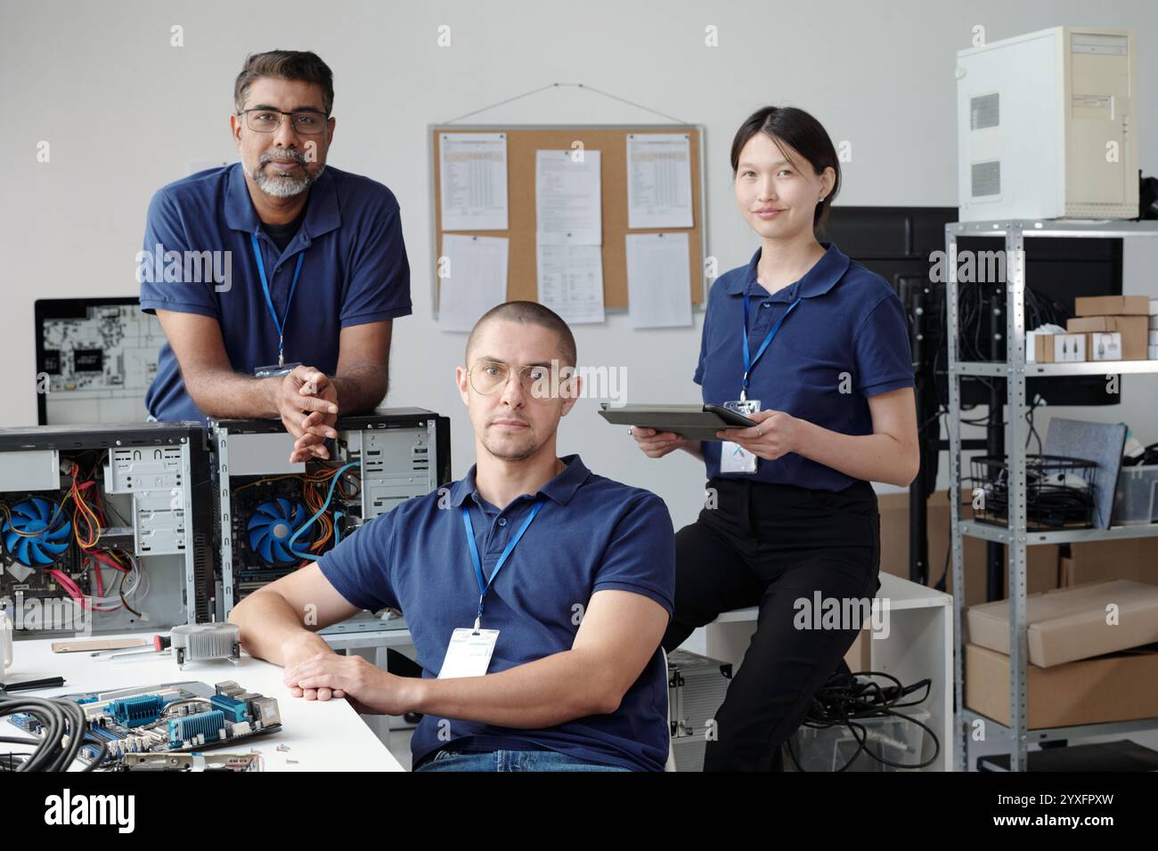 Group of IT Professionals Working on Computers in Office Stock Photo