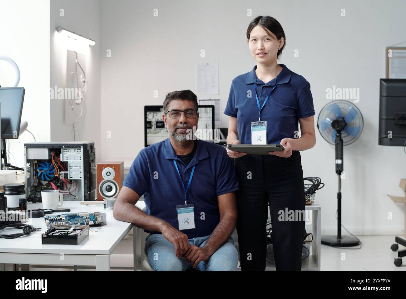 Smiling Colleagues Collaborating on Technology Project Stock Photo