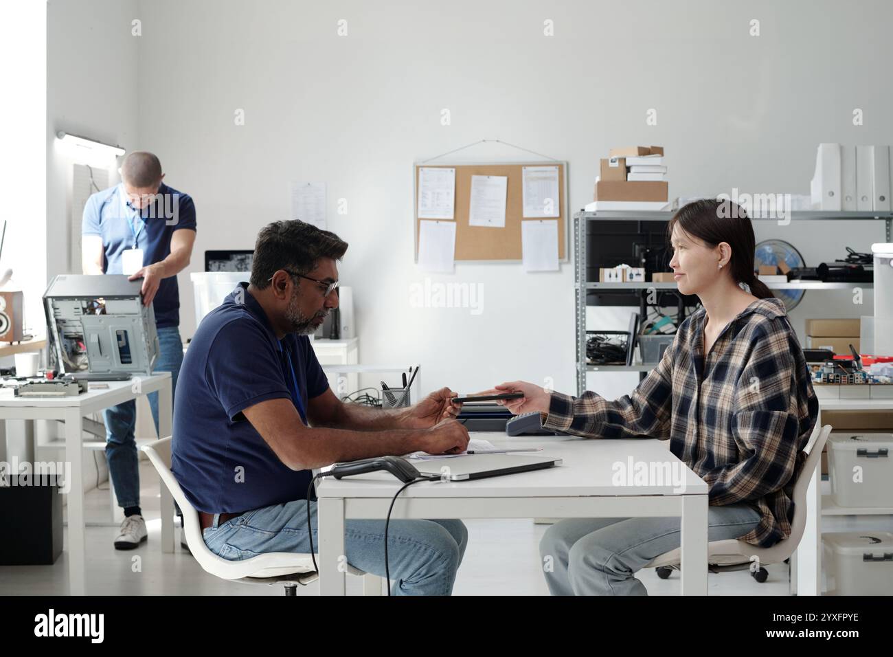 Collaborating in Modern Office Setting With Tech Gadgets Stock Photo