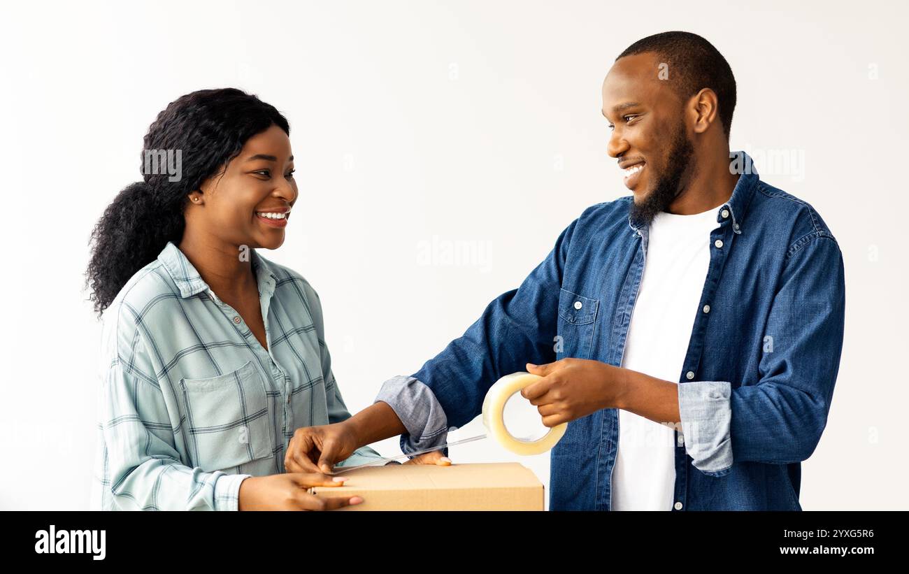Joyful woman packing cardboard hi-res stock photography and images - Alamy