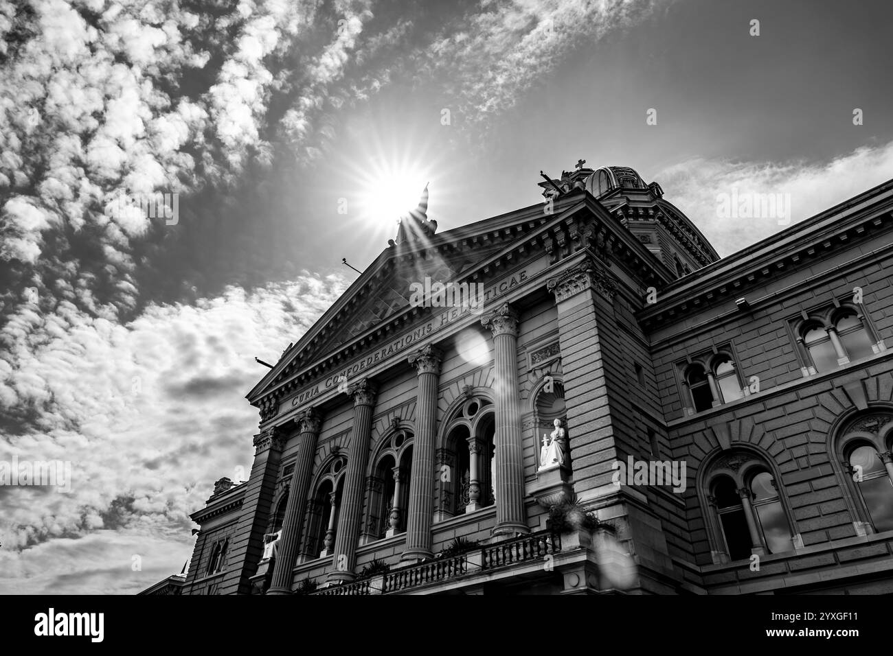 Beautiful Bundeshaus Parliament Building or Federal Palace in a Sunny Day with Sunbeam and Lens Flare in City of Bern, Canton Bern, Switzerland. Stock Photo