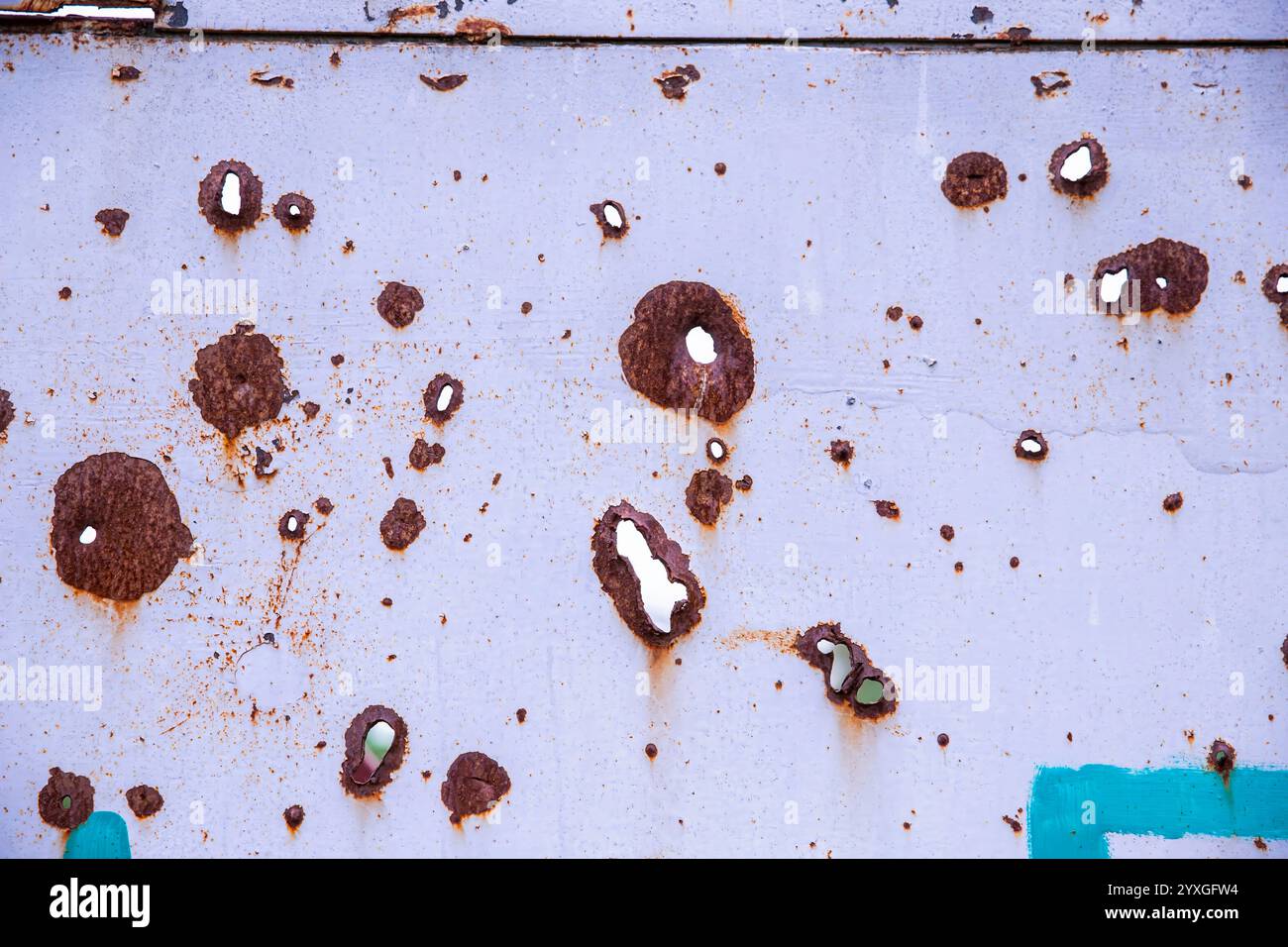 Rusty Bullet Holes on Metal Surface, Symbol of War and Conflict Stock Photo