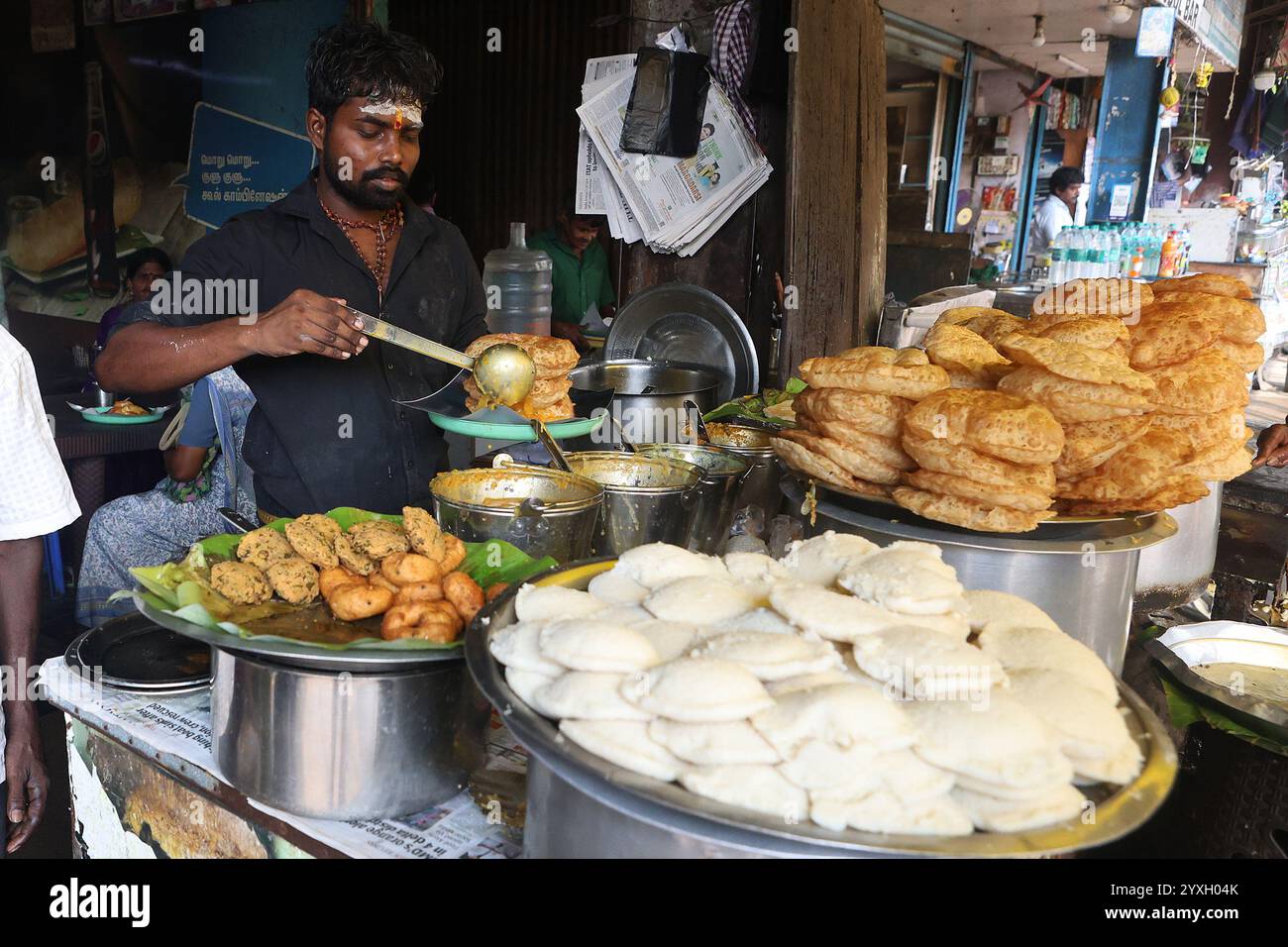 Vendor serving tiffin at a food stall in the George Town district of ...