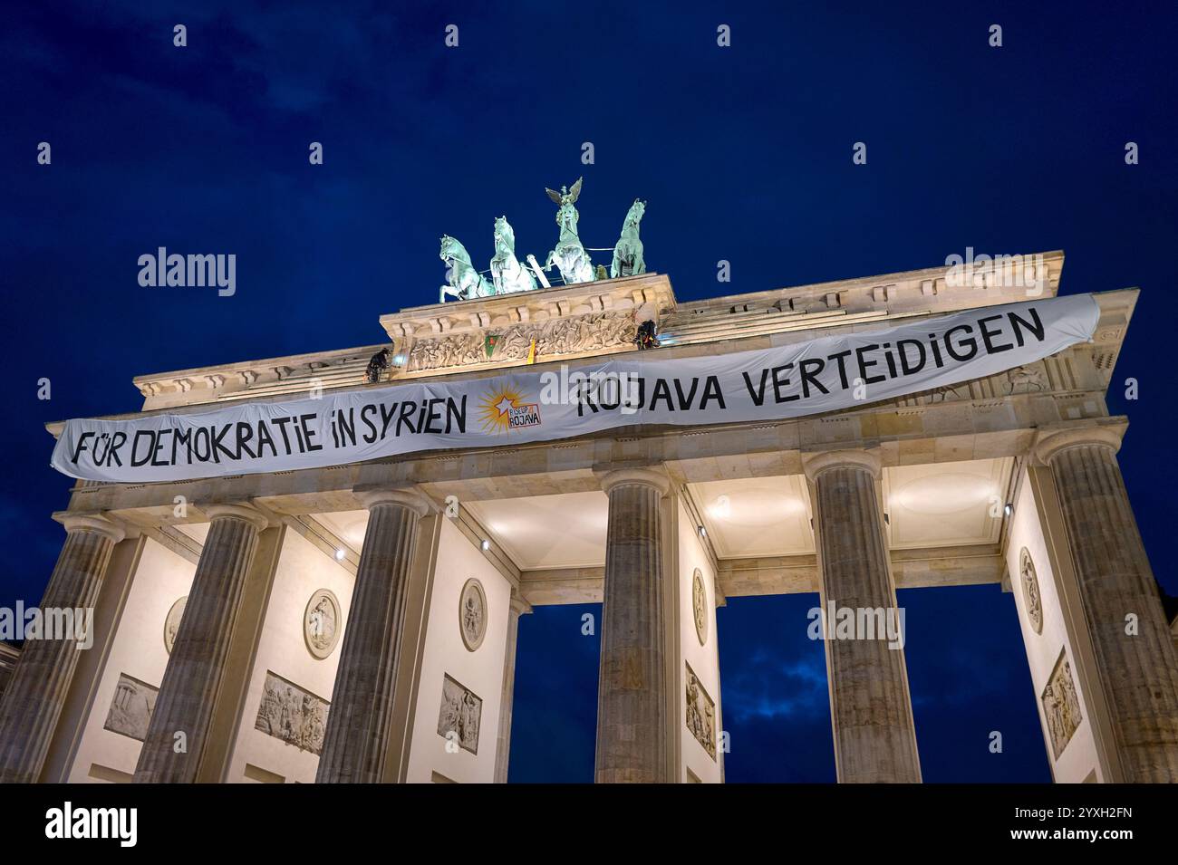 Berlin, Germany. 16th Dec, 2024. Activists unfurl a banner at the ...