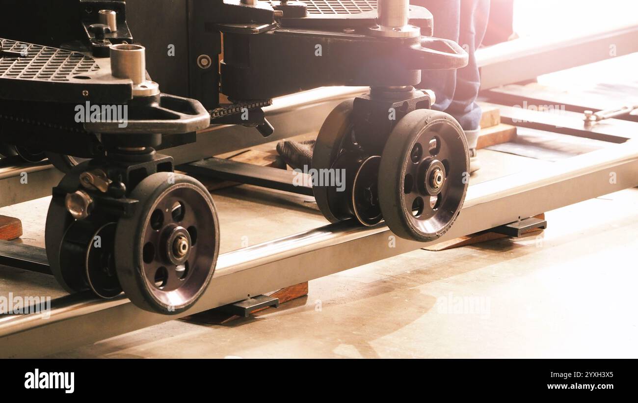 Camera trolley or camera dolly cart rails for filmmaking on studio shooting set. Pro videographer dolly rail track for filming movie mounted on studio Stock Photo