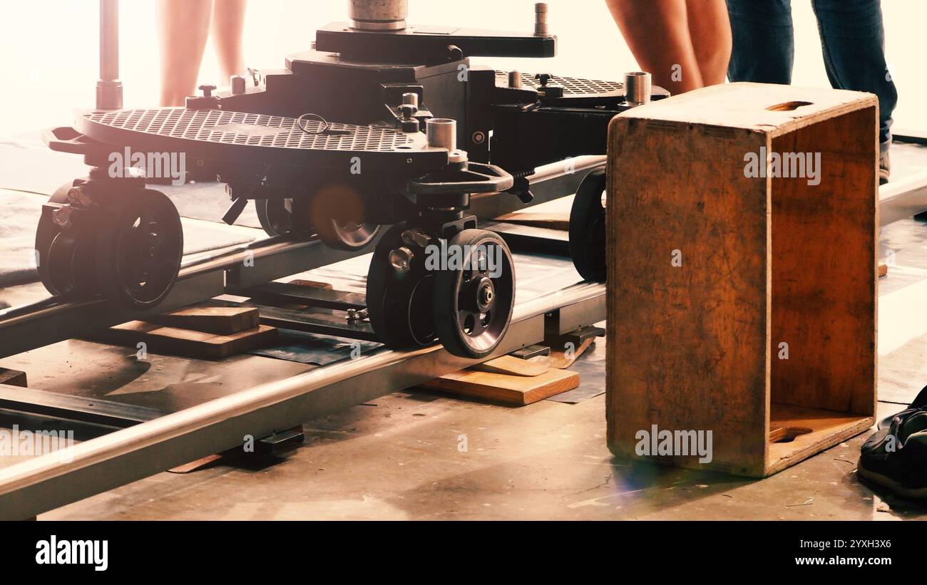 Camera trolley or camera dolly cart rails for filmmaking on studio shooting set. Pro videographer dolly rail track for filming movie mounted on studio Stock Photo