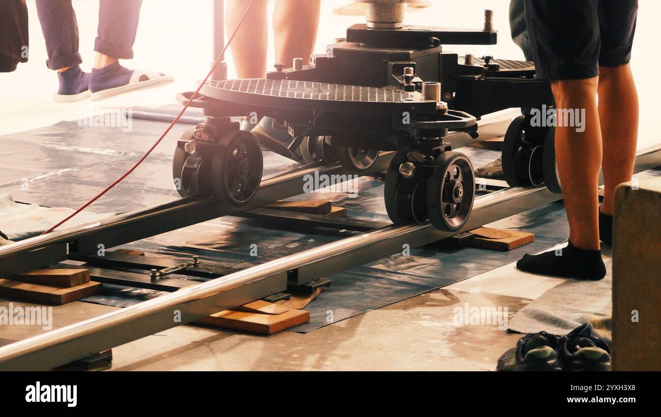 Camera trolley or camera dolly cart rails for filmmaking on studio shooting set. Pro videographer dolly rail track for filming movie mounted on studio Stock Photo
