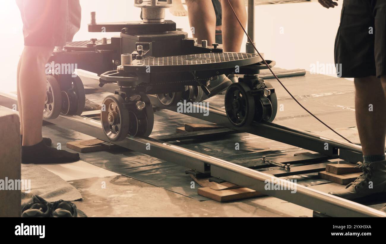 Camera trolley or camera dolly cart rails for filmmaking on studio shooting set. Pro videographer dolly rail track for filming movie mounted on studio Stock Photo
