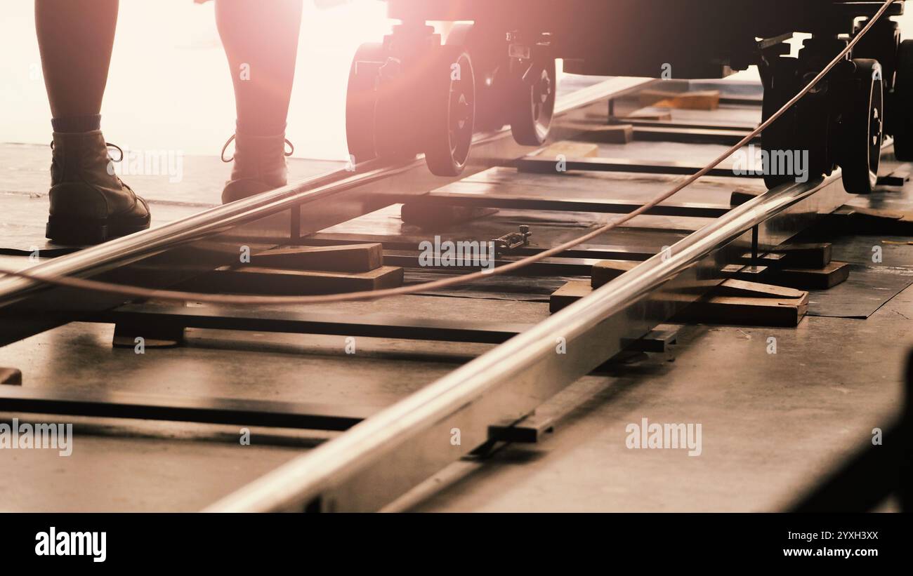 Camera trolley or camera dolly cart rails for filmmaking on studio shooting set. Pro videographer dolly rail track for filming movie mounted on studio Stock Photo