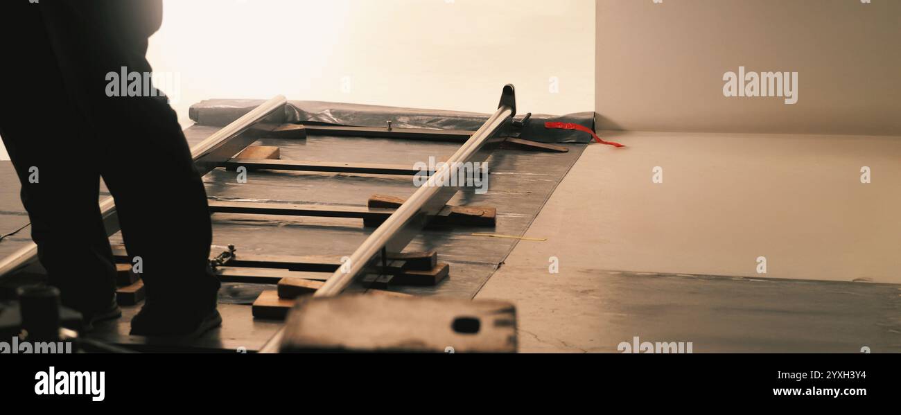 Camera trolley or camera dolly cart rails for filmmaking on studio shooting set. Pro videographer dolly rail track for filming movie mounted on studio Stock Photo