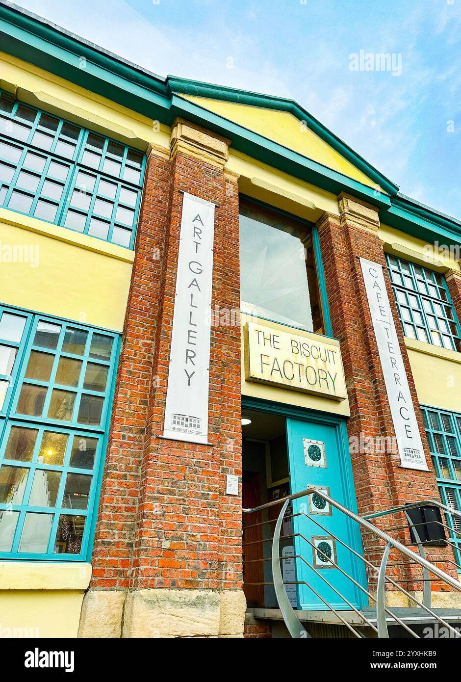 Exterior view of the Biscuit Factory art gallery and cultural space with entrance banners and a clear sky newcastle upon tyne uk - Smartphone Captured Stock Image