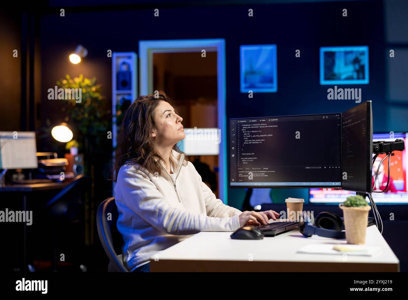 System administrator looking at AR visualization to fix vulnerabilities in software. Cybersecurity specialist using computer to patch security exposures using augmented reality tech Stock Photo