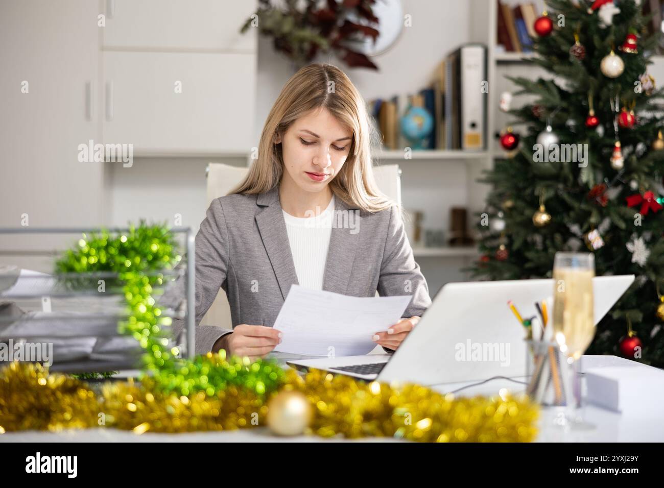 Woman working with documents during Christmas Stock Photo
