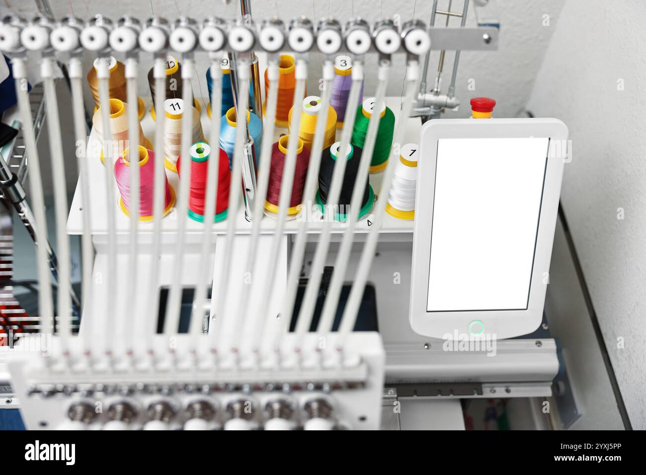 Modern embroidery machine with spools of thread indoors, closeup Stock ...