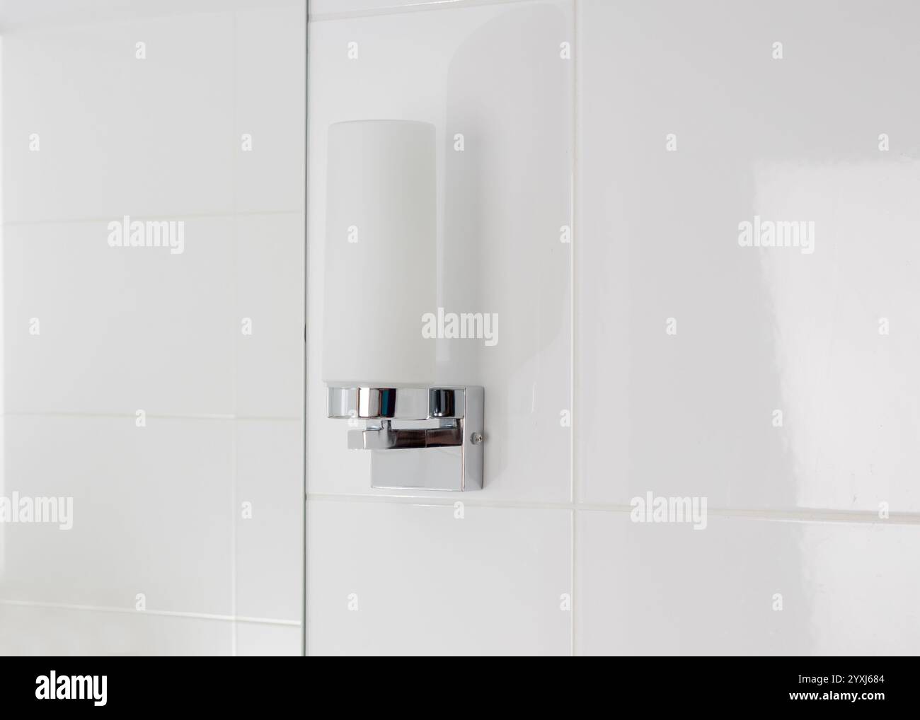 Modern Bathroom Wall Light Fixture on White Tile Stock Photo